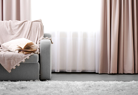 Grey room with bright window and chic curtains