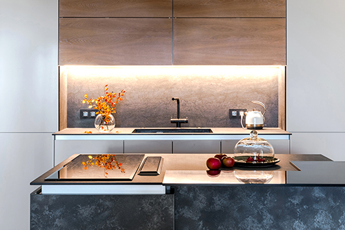 Modern minimalist kitchen with wood cabinetry, under-cabinet lighting, and stone backsplash — sleek and sophisticated style update.